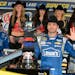 Jimmie Johnson poses for photos in victory lane after winning the NASCAR Sprint Cup Series auto race at Texas Motor Speedway in Fort Worth, Texas, Sun
