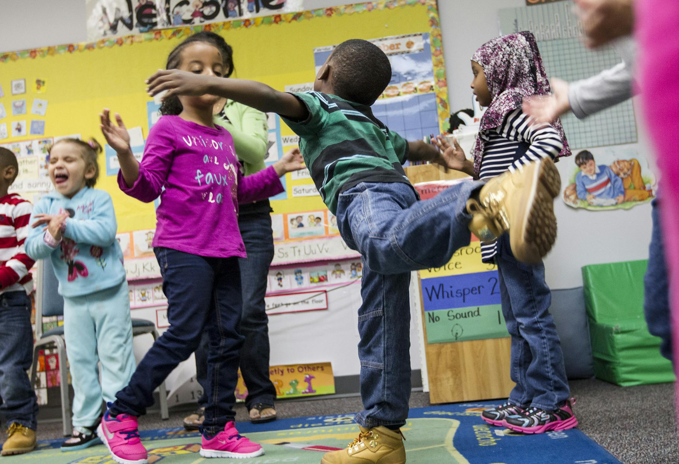 Preschool student Emmanuel Geebli stands on one leg while dancing with classmates during a learning activity at the Head Start Family Development Center in Coon Rapids October 6, 2014. (Courtney Perry/Special to the Star Tribune)