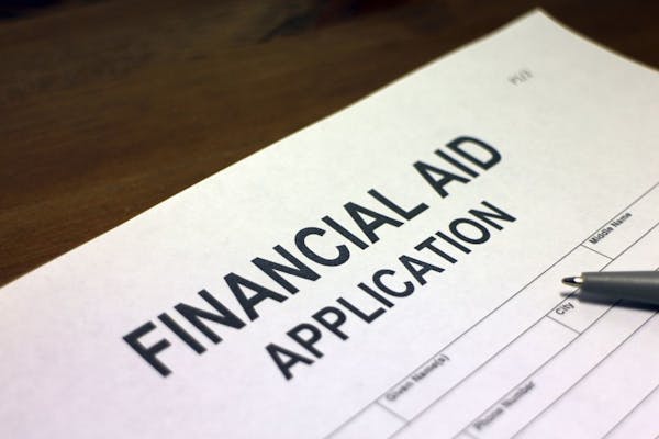 Someone filling out Financial Aid Application form. istock photo