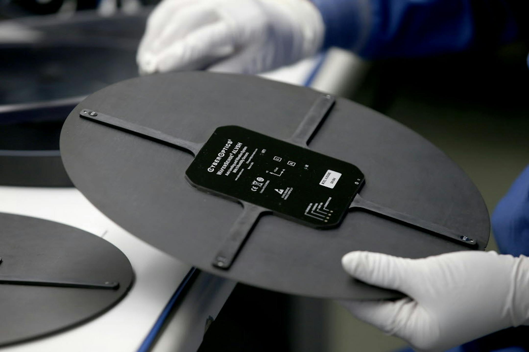 Lynn Martinson, a production trainer at CyberOptics, worked on an Autospace Multi Sensor (AMS) at her workstation, Friday, July 10, 2015 in Golden Valley, MN. ] (ELIZABETH FLORES/STAR TRIBUNE) ELIZABETH FLORES &#x2022; eflores@startribune.com
