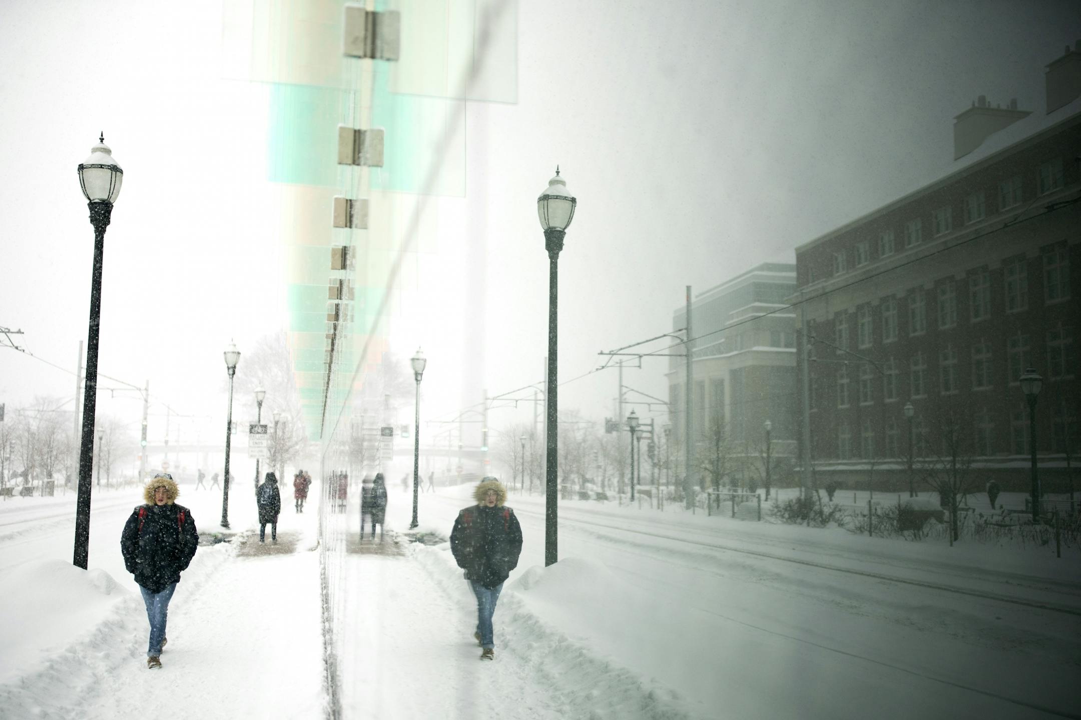 Students at the University of Minnesota walked along Amundson Hall on Wednesday as the snow moved in.