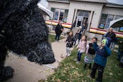 Puppeteer Christopher Lutter-Gardella, wearing a black bear outfit, entertained kids outside the Giiwedinong Treaty Rights and Culture Museum, which o