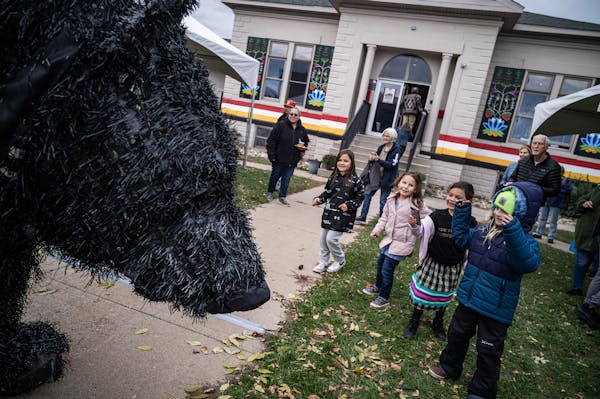 Puppeteer Christopher Lutter-Gardella, wearing a black bear outfit, entertained kids outside the Giiwedinong Treaty Rights and Culture Museum, which o