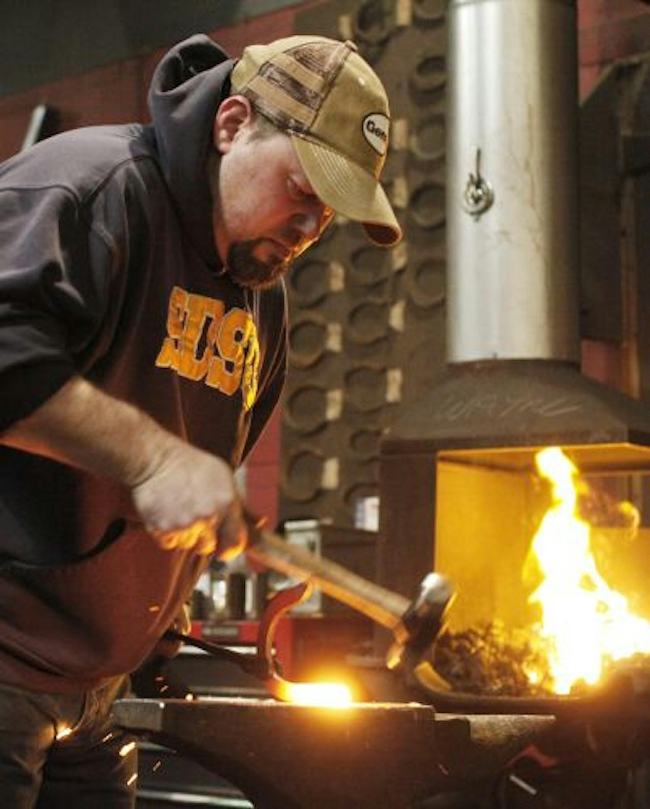 Student Ross Scheevel of Lester Prairie, Minn., practiced pounding a red-hot horseshoe into shape. The Minnesota School of Horseshoeing's course runs 10 weeks. Even in a down economy, horse's hooves still must be trimmed and shod.