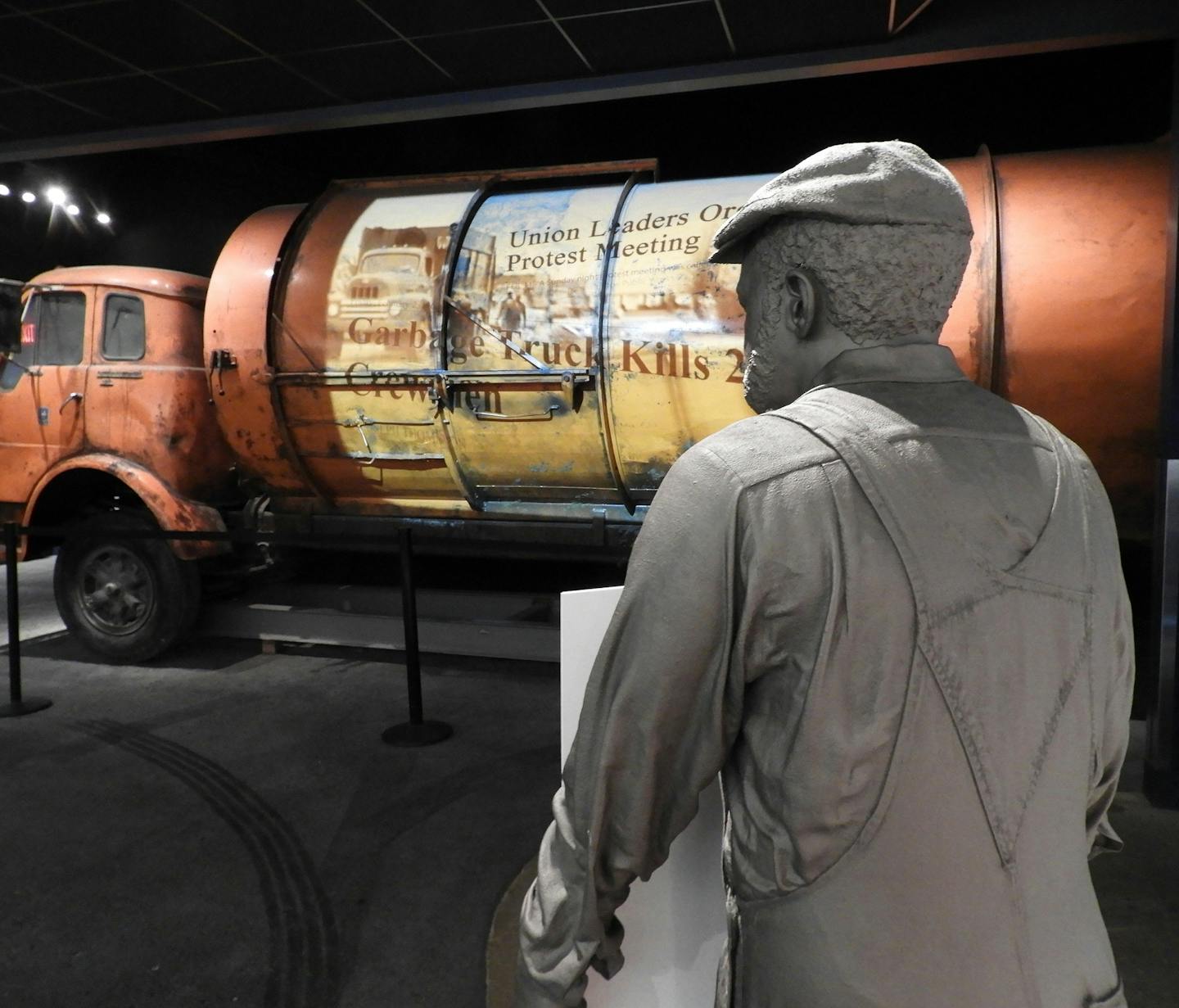 Newspaper headlines from 1968 are projected onto the side of an old garbage truck inside the National Civil Rights Museum, which shares the story of the sanitation workers strike that fatefully brought Rev. King to Memphis. (Jay Jones/Chicago Tribune/TNS)