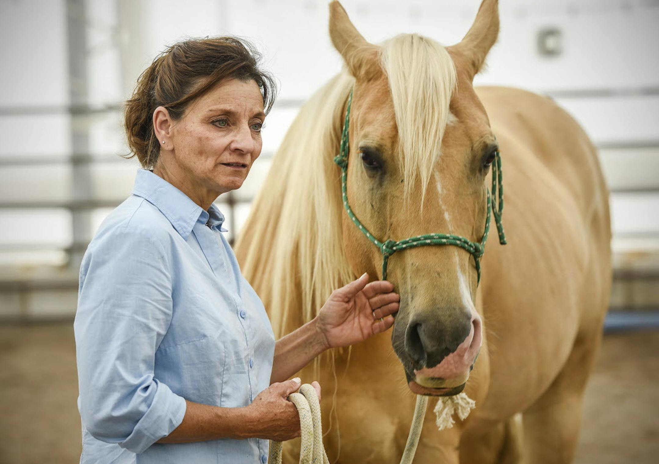 ADVANCE FOR USE WITH WEEKEND EDITIONS SATURDAY, JULY 14, 2018 In this Wednesday, June 27, 2018 photo, Jodine Rothstein talks about opening her equine-assisted therapy center called Gaits of Hope at her Sandy Knoll Farm in Rice, Minn. The center serves veterans and children with mental health issues. (Jason Wachter/St. Cloud Times via AP)