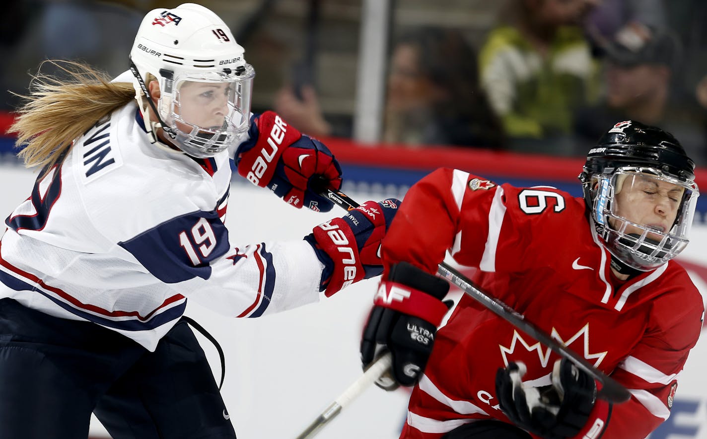 Gigi Marvin (19) of team USA and Jayna Hefford (16) of team Canada battled for the puck in the third period. USA beat Canada by in final score of 3-2 in an overtime shootout. ] CARLOS GONZALEZ cgonzalez@startribune.com - December 28, 2013, St. Paul, Minn., Xcel Energy Center, Womens Hockey, USA vs. Canada