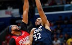 Minnesota Timberwolves center Karl-Anthony Towns (32) goes to the basket against New Orleans Pelicans forward Anthony Davis during the first half of a