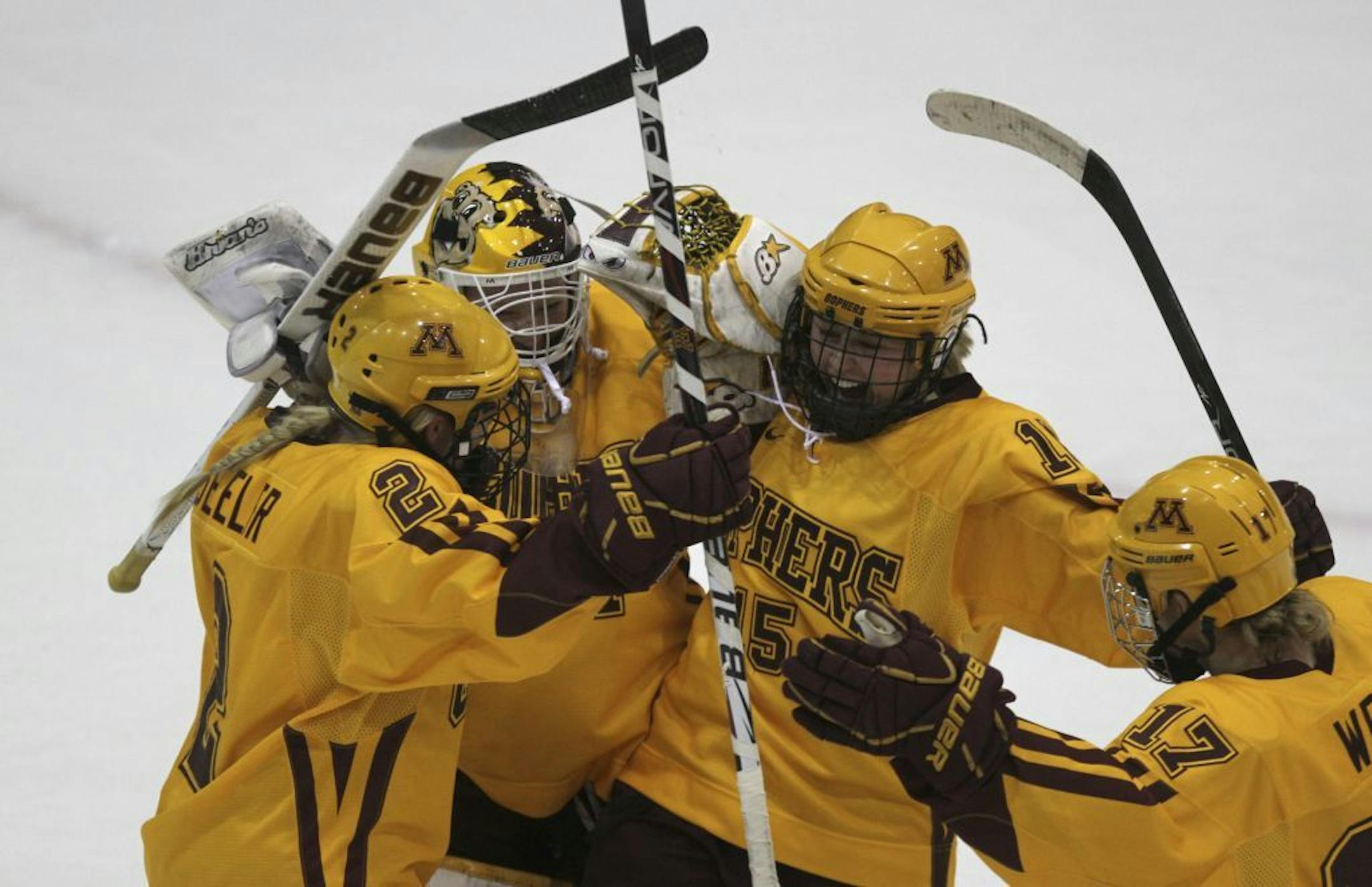 Minnesota's players from left, Kelly Seeler, Noora Raty, Rachael Bona and Emily West celebrated their win against North Dakota at Ridder in Minneapolis Min., Saturday, March 10, 2012. Minnesota won 5-1.