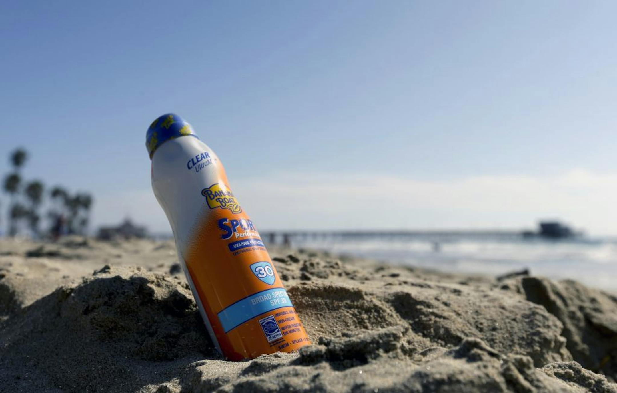 A bottle of Banana Boat sunscreen is placed in the sand near the Newport Beach pier in Newport Beach Calif., Friday, Oct. 19, 2012. The maker of Banana Boat sunscreen is recalling some of its spray-on products after reports that a handful of people who have caught on fire after applying the lotion and standing near open flames. The bottle was placed in the sand by the photographer to illustrate this report.