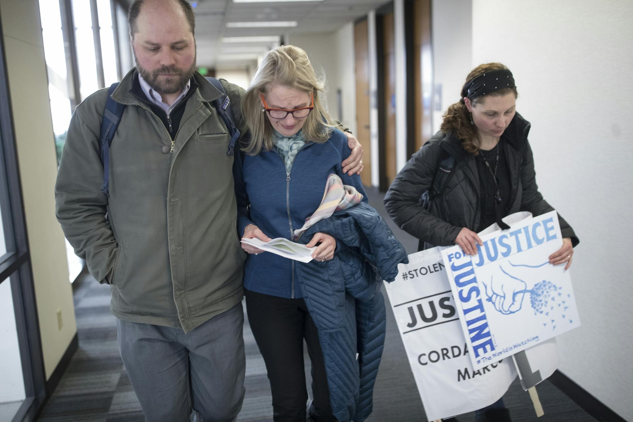 Drew Rosielle, left, and Sarah Kuhnen of, Justice for Justine Damond Ruszczyk left a press conference where Hennepin County Attorney Mike Freeman described the charges against Minneapolis Police officer Mohamed Noor.