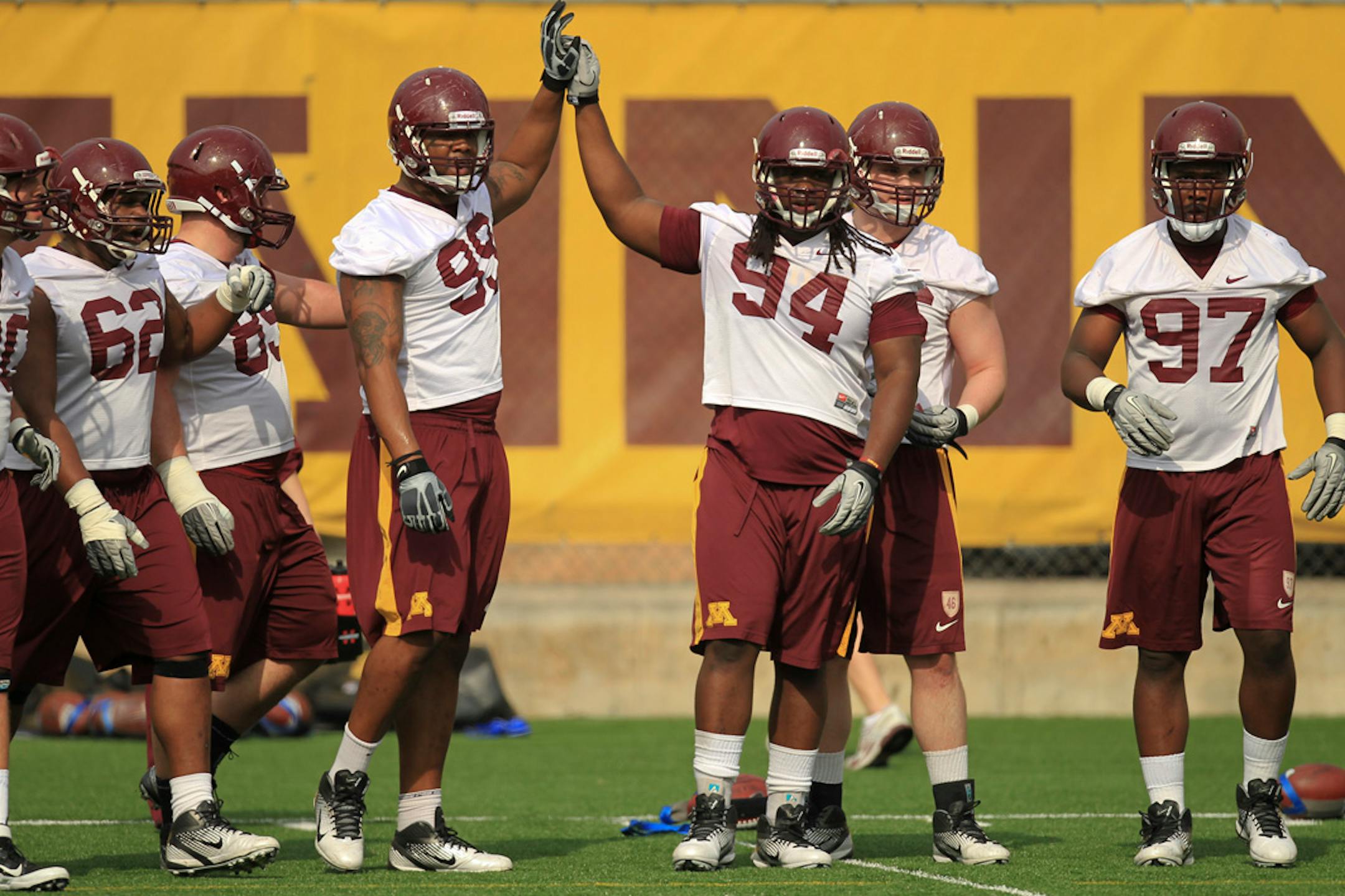 The University of Minnesota football team held their first spring practice Wednesday afternoon, March 22, 2012 at the Bierman Football Complex field on the Minneapolis campus. Defensive linemen Ra'Shede Hageman (99) with Harold Legania (94) and other linemen during the first day of spring practice Wednesday afternoon.