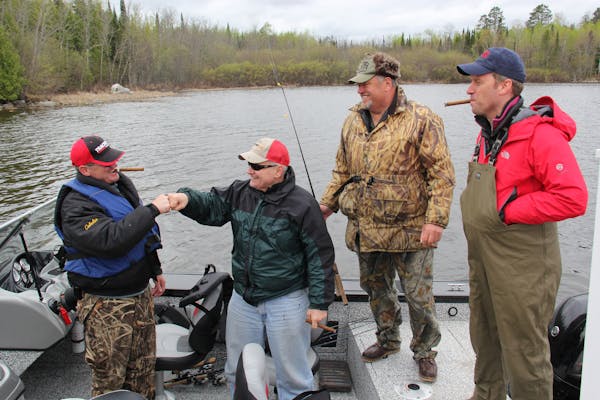Governor Mark Dayton thanks his fishing guide, Buck Lescarbeau, with a fist bump at the 2015 fishing opener.