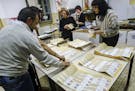 Scrutineers count votes in a polling station in Rome, Sunday, March 4, 2018, at the end of the general election day in Italy. The campaign was marked 