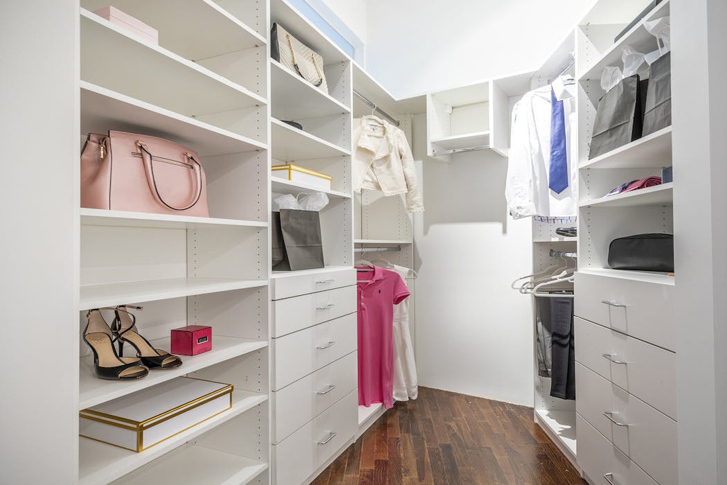 White cabinetry helps keep this closet modern and fresh.