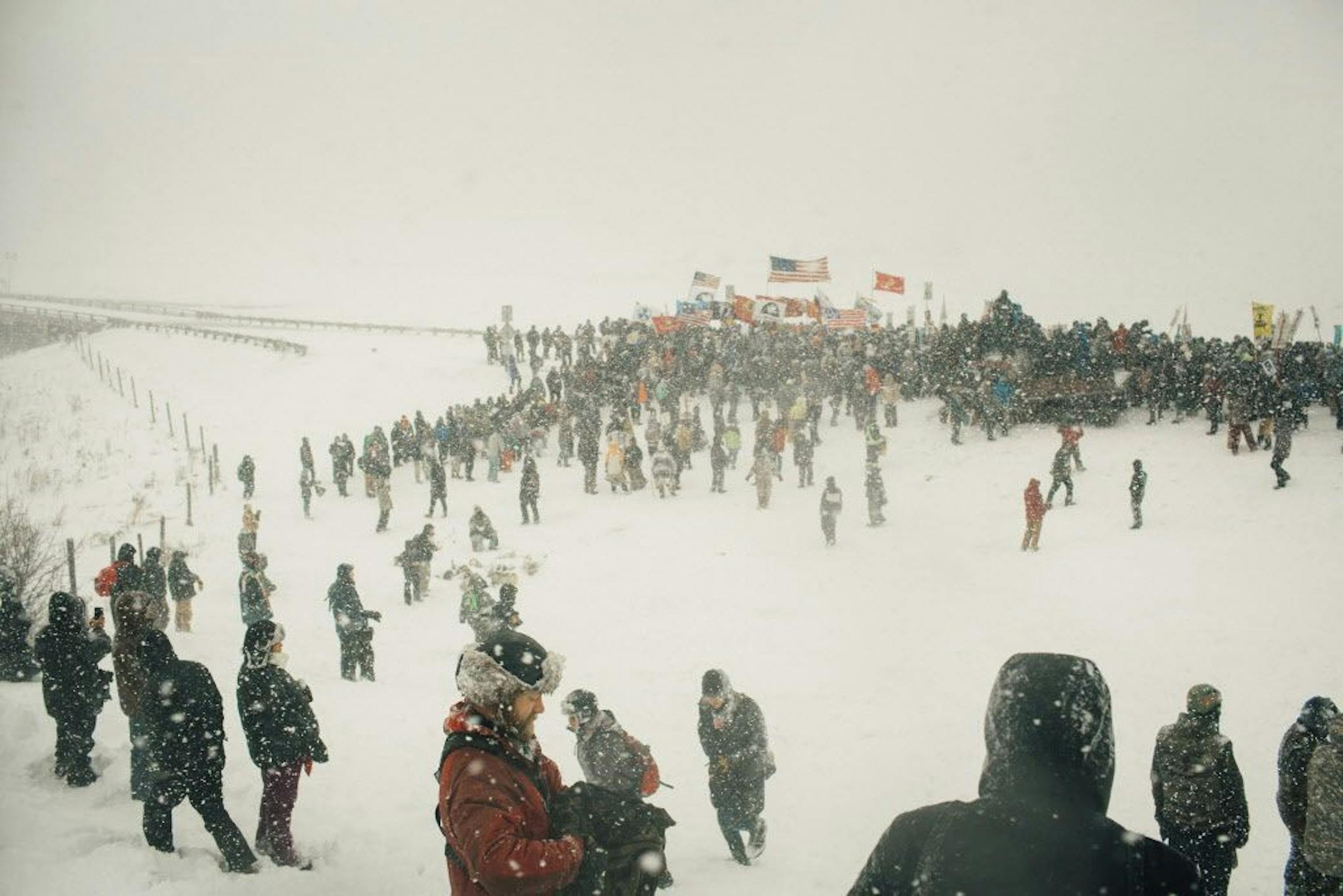 Protesters demonstrate against the Dakota Access Pipeline in Cannon Ball, N.D., Dec. 5, 2016. After months of protest, prayer and violent clashes with law enforcement, leaders of the protest have called for a withdrawal from the snowpacked prairie.