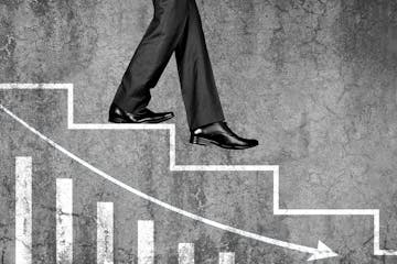 Low section view of a businessman moving down on stairs with graph chart representing the concept of Loss, Failure, Problems etc.