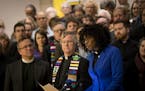 As dozens of clergy people stood behind JaNa� Bates, a United Church of Christ minister and communications director of ISAIAH, as she announced 13 c