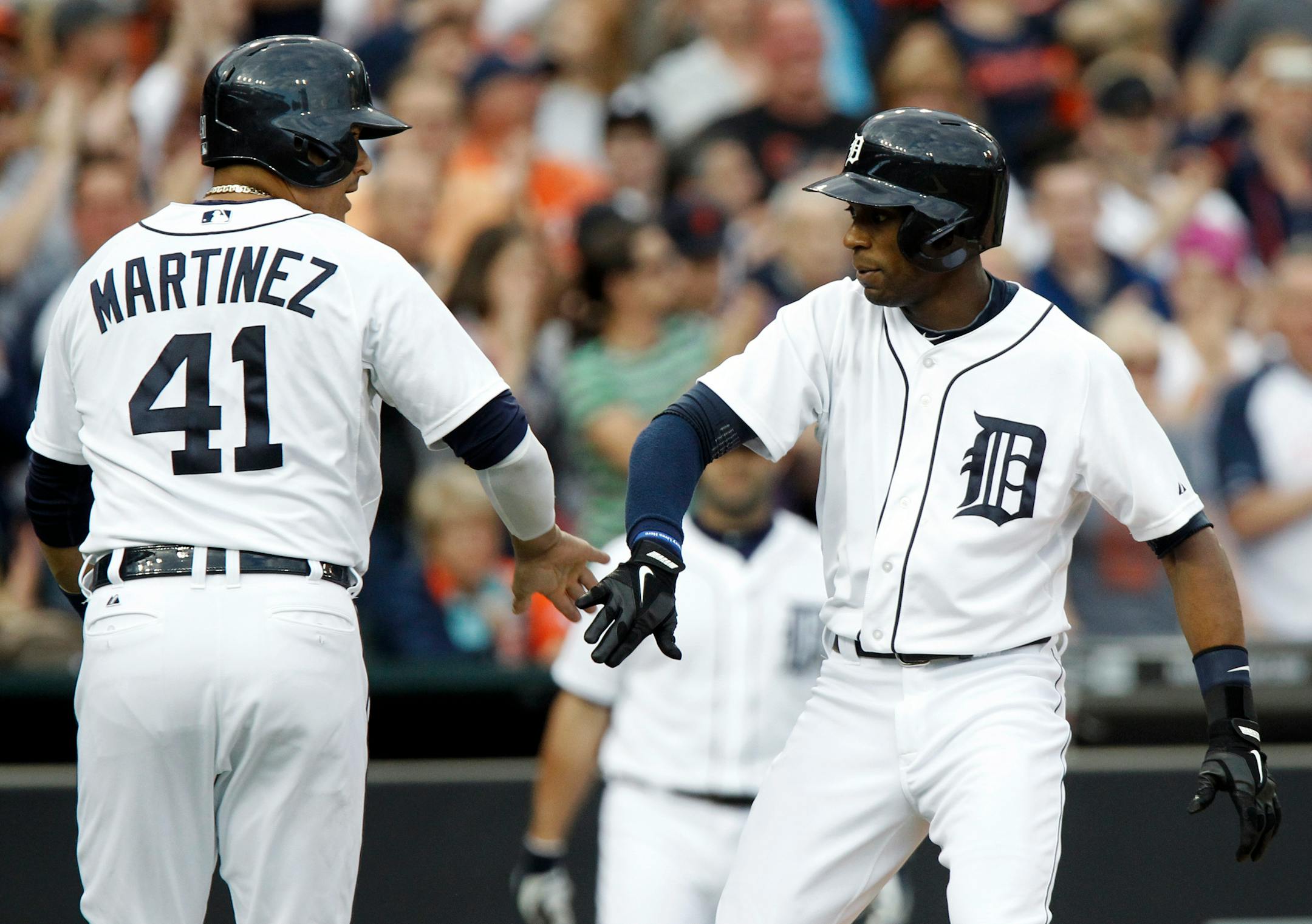 Detroit Tigers' Austin Jackson, right, is congratulated by teammate Victor Martinez (41) after hitting a two-run home run against the Texas Rangers in the second inning of a baseball game Friday, May 23, 2014, in Detroit. (AP Photo/Duane Burleson)