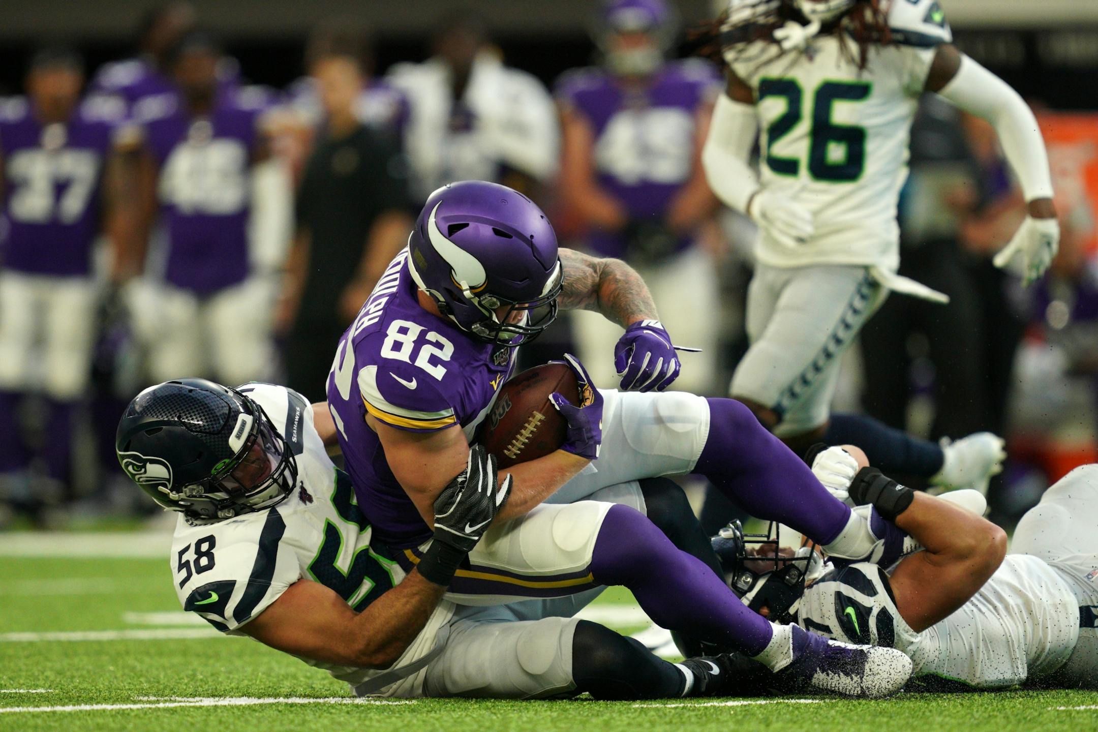 Minnesota Vikings tight end Kyle Rudolph (82) was brought down by Seattle Seahawks outside linebacker Austin Calitro (58) the first half.
