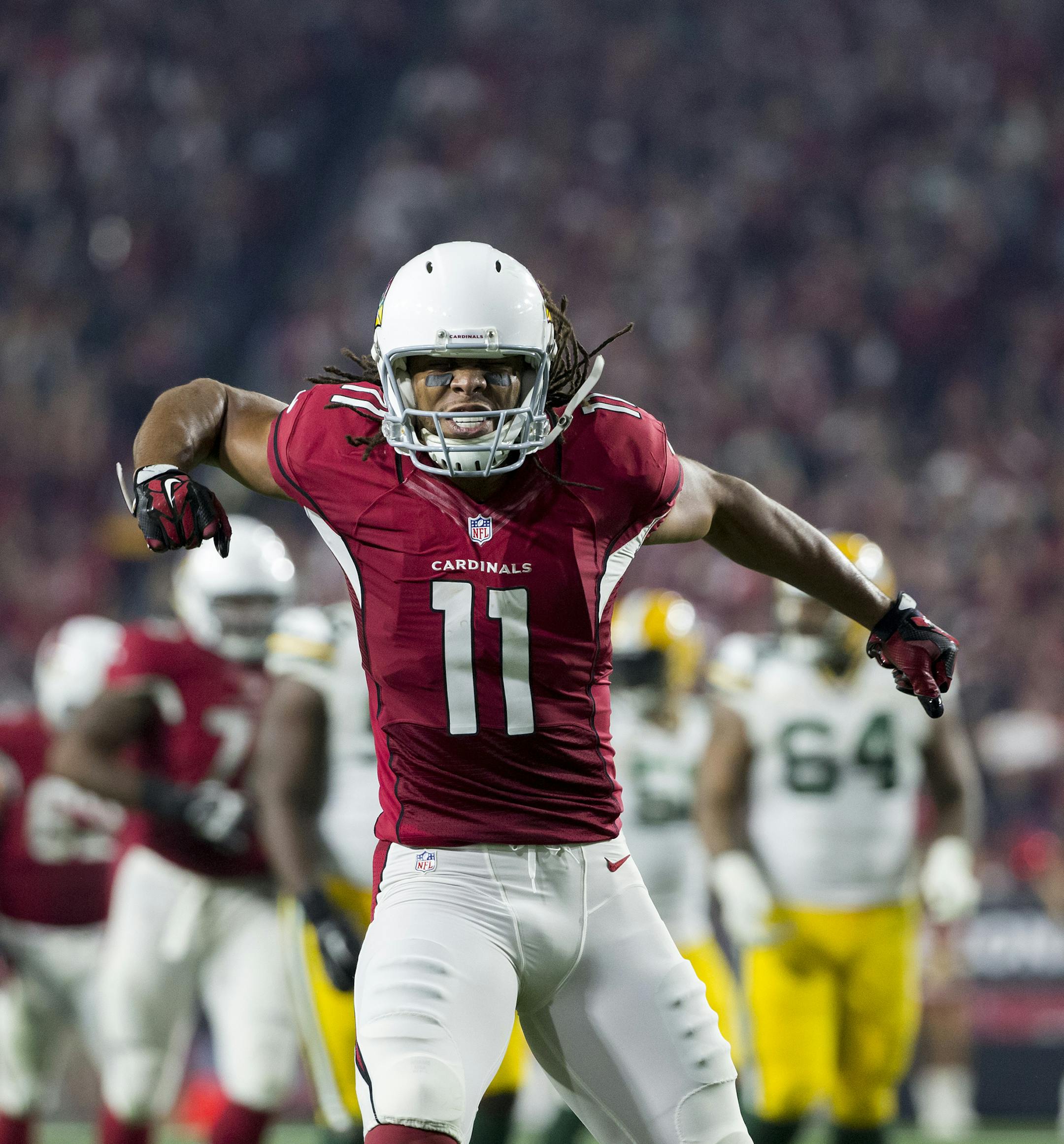 Arizona Cardinals wide receiver Larry Fitzgerald (11) celebrates his big catch during an NFC Divisional Playoff game against the Green Bay Packers on Saturday, Jan. 16, 2016, in Glendale, Ariz. The Cardinals won the game in overtime, 26-20. (Greg Trott via AP) ORG XMIT: GTAZ01