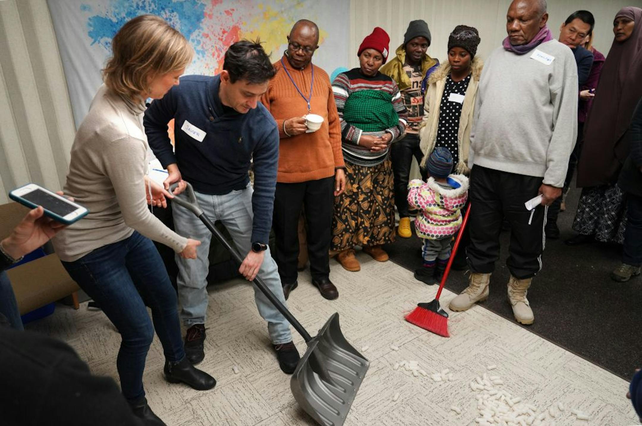 St. Paul nonprofit International Institute of MN helps new Americans make the transition to life in the United States. Among the services they offer is a series of classes titled "Live in MN", that includes everyting from how to navigate the legal system and gain employment as well as Mn-specific education such as how to shovel and dress for winter. Here, Sara Skinner helps demonstrated for Javier Ruiz-Medrano how to use a shovel to avoid back injury.