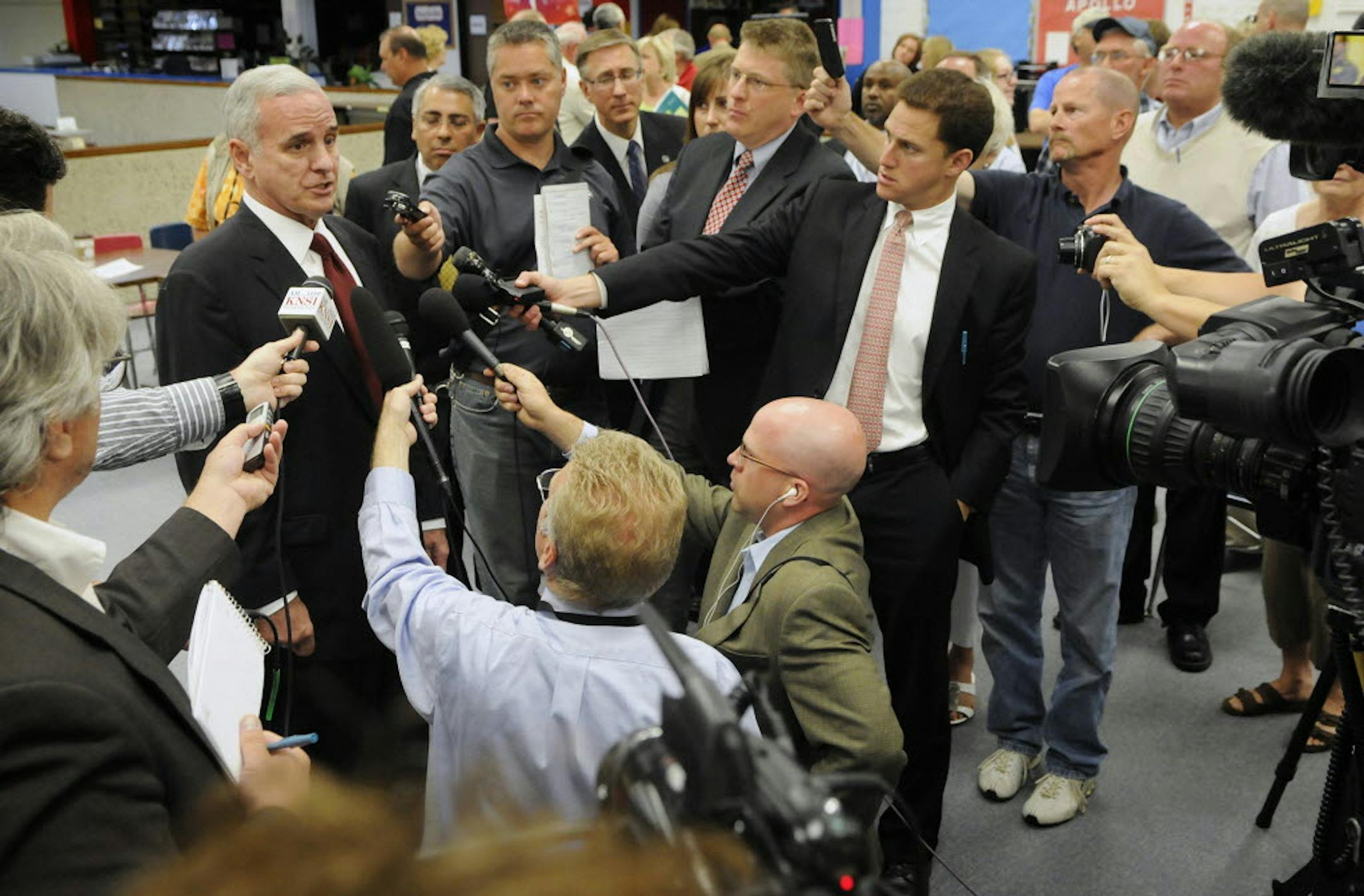 Gov. Mark Dayton answers questions after attending an education roundtable discussion at Apollo High School Tuesday in St Cloud.