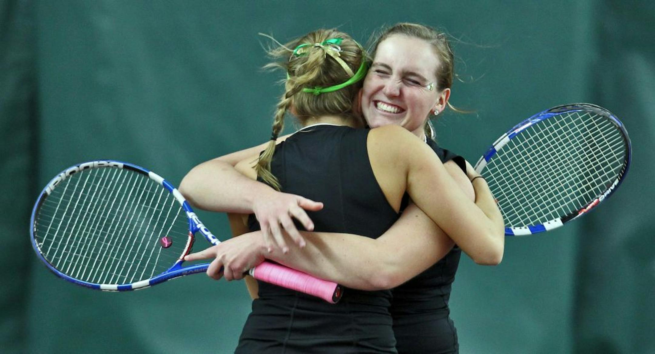 Edina's Meghan Herring (face to camera) hugged her doubles partner Morgan Marinovich after they won their championship match.