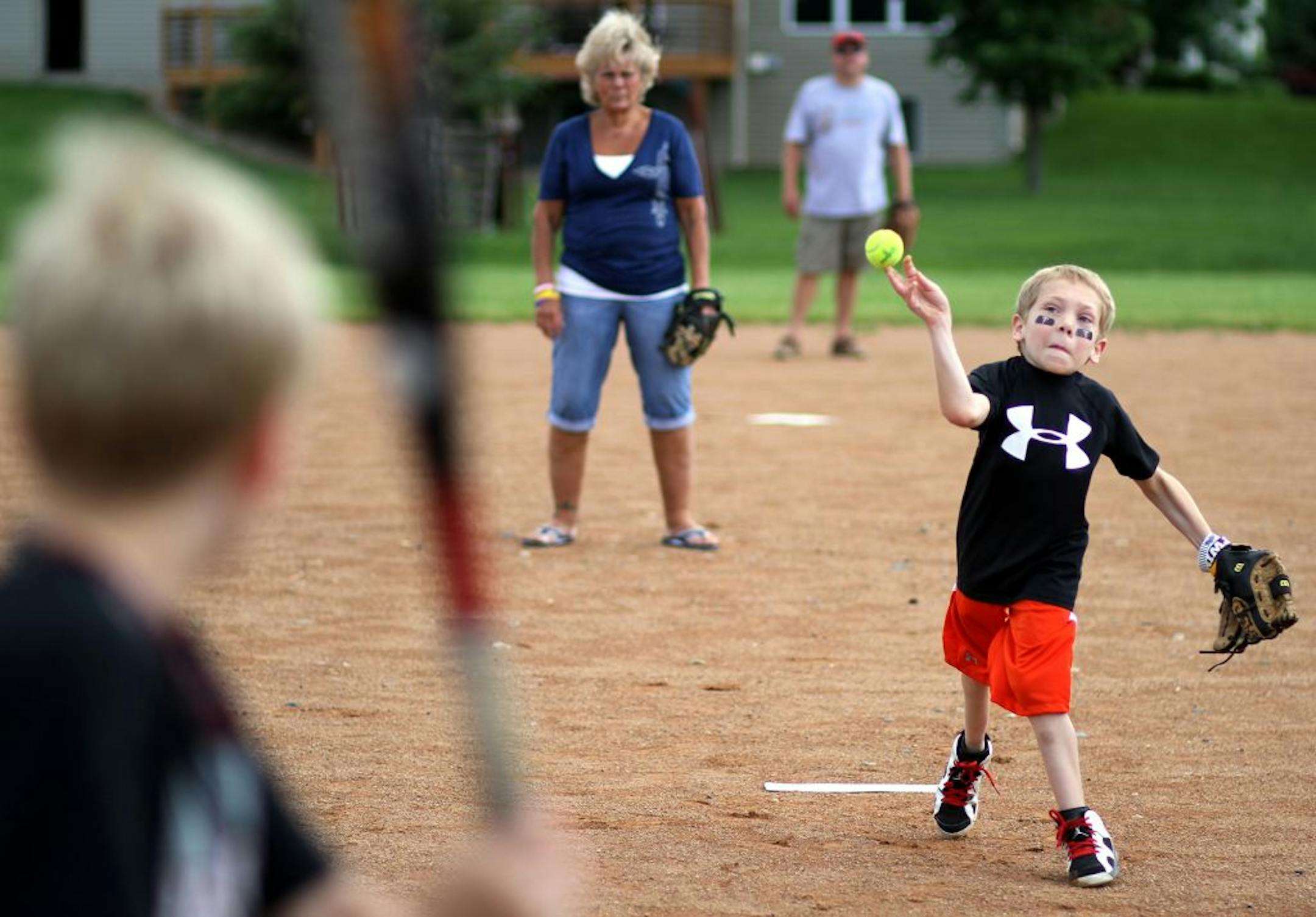 Logan Swedburg pitched a tennis ball to his friend at a game of baseball during his 11th birthday party Monday at a park in Lakeville, Minn.