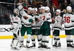 Minnesota Wild players celebrate after defeating the Vegas Golden Knights 4-2 in an NHL hockey game Friday, March 16, 2018, in Las Vegas. (AP Photo/Jo