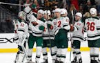 Minnesota Wild players celebrate after defeating the Vegas Golden Knights 4-2 in an NHL hockey game Friday, March 16, 2018, in Las Vegas. (AP Photo/Jo