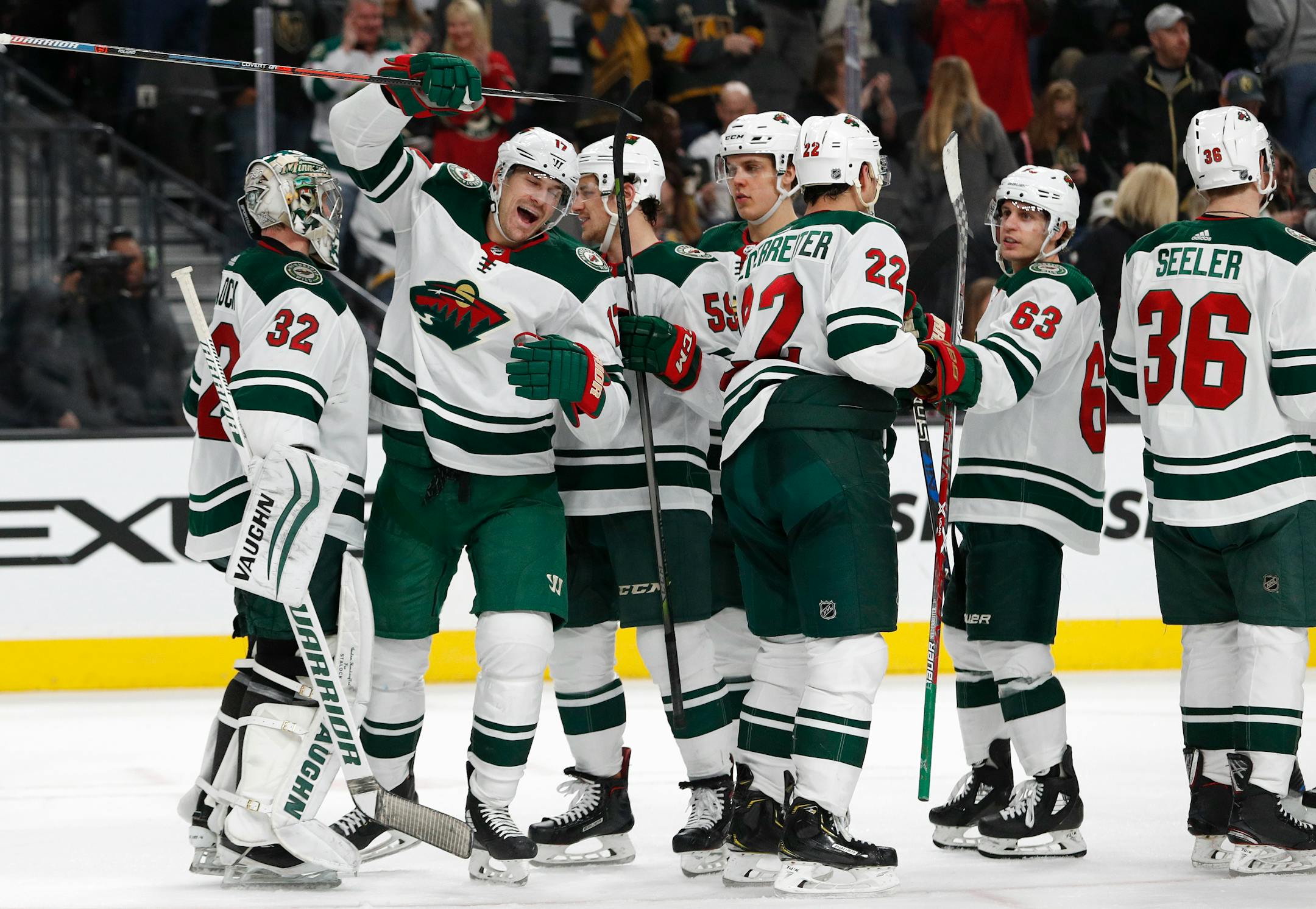 Minnesota Wild players celebrate after defeating the Vegas Golden Knights 4-2 in an NHL hockey game Friday, March 16, 2018, in Las Vegas. (AP Photo/John Locher)