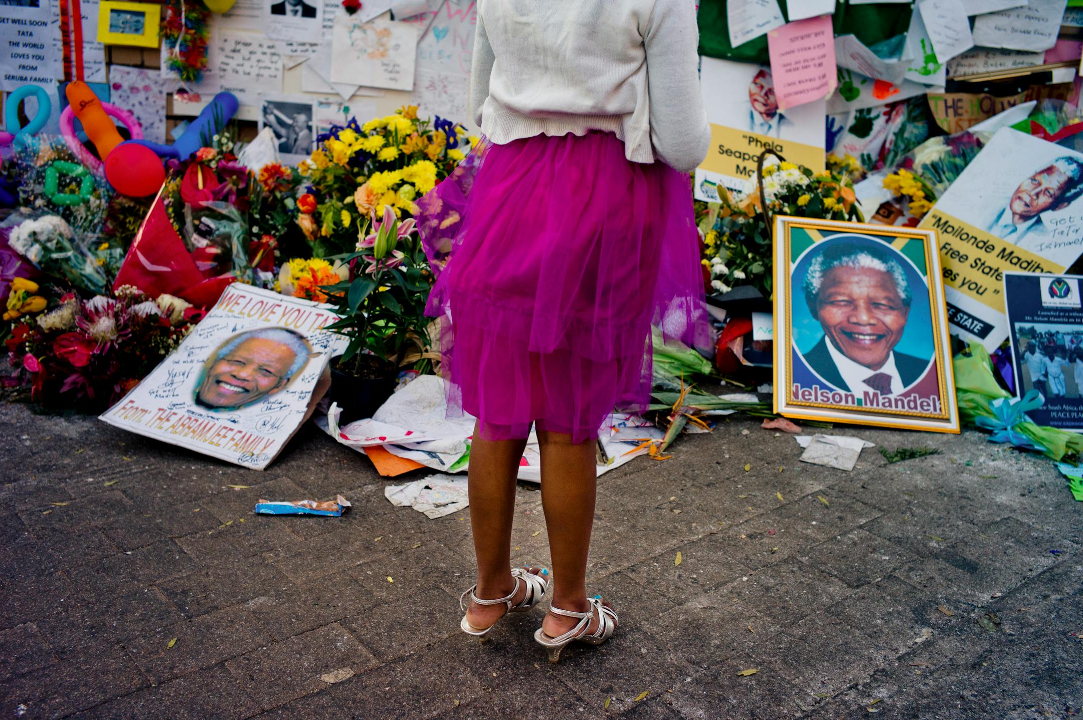 A girl visits a makeshift shrine to Nelson Mandela, the iconic South African leader, in Pretoria, South Africa, where he his hospitalized, on July 4, 2013. Mandela is in critical condition with a lung infection. (Tomas Munita/The New York Times)