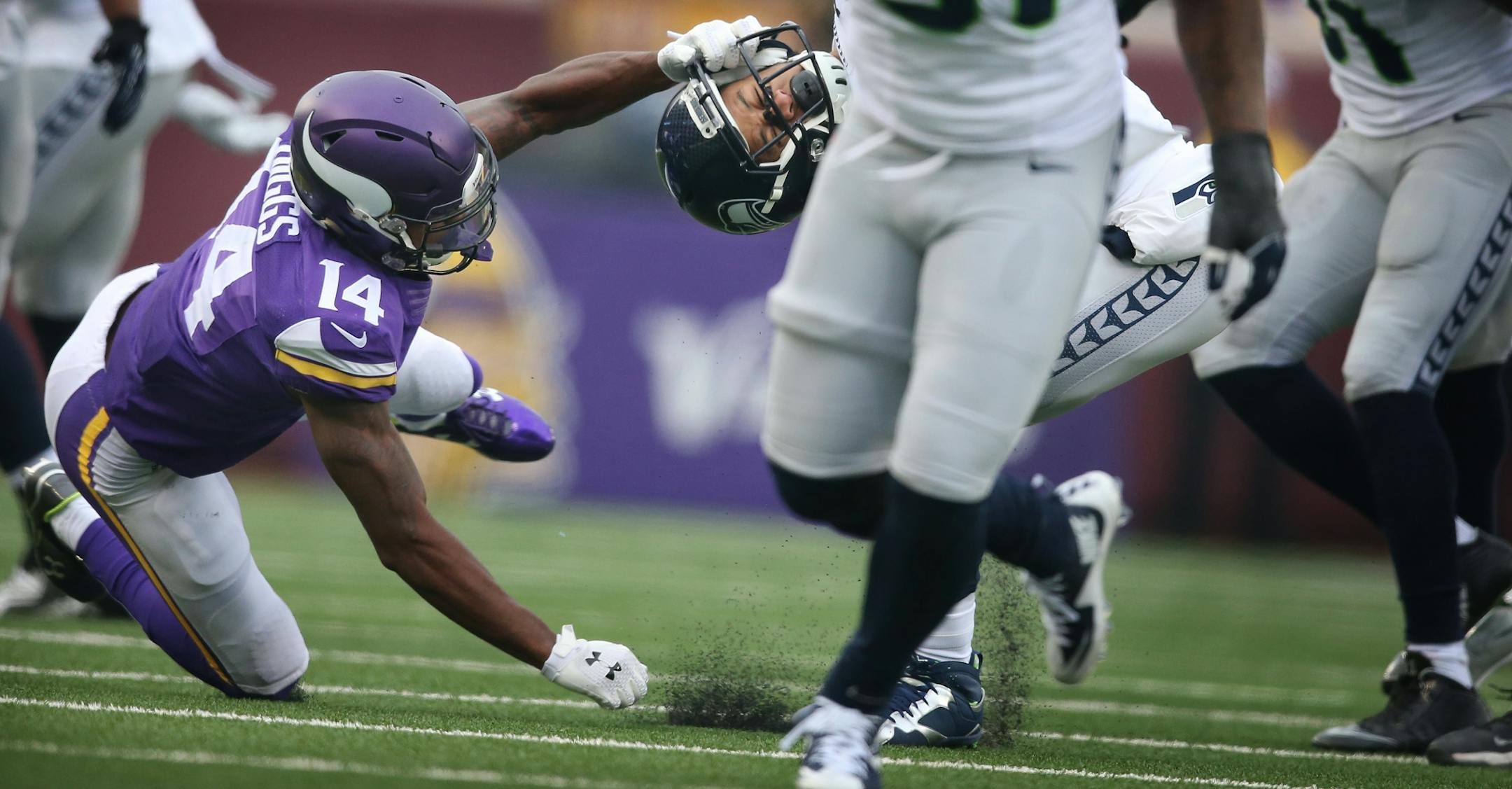 Minnesota Vikings wide receiver Stefon Diggs (14) was called for face masking on Seattle Seahawks free safety Earl Thomas (29) after he intercepted a Teddy Bridgewater pass Sunday December 6, 2015 in Minneapolis, MN.