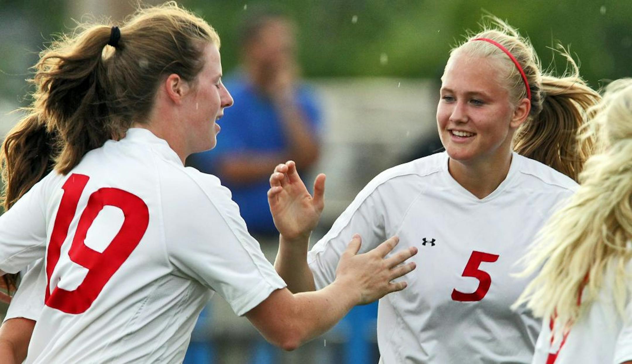 Benilde-St. Margaret's girls soccer game vs. Holy Angels for soccer preview. Photos of BSM players Anne Arnason and Haley Jerabek and head coach Scott Helling-Christy. Anne Arnason, right, congratulated teammate Kelly Pannek (19) after Pannek scored a goal. (MARLIN LEVISON/STARTRIBUNE(mlevison@startribune.com (cq Anne Arnason, Haley Jerabek and Scott Helling-Christy.))