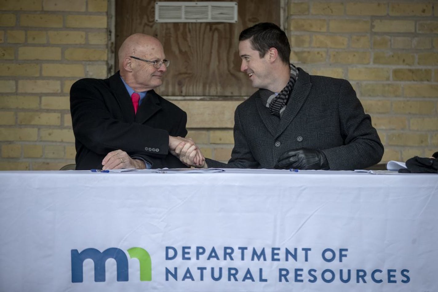 DNR Commissioner Tom Landwehr, and Dominium's Owen Metz shook hands after signing an agreement with Dominium, an affordable housing development and management company, to renovate 26 historic buildings at Fort Snelling Upper Post, Wednesday, November 21, 2018 in St. Paul, MN.