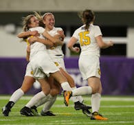 Mahtomedi's Sonia Meyer, left, was congratulated by teammate Anna Wagner (22) after she headed in a corner kick for what proved to be the winning goal