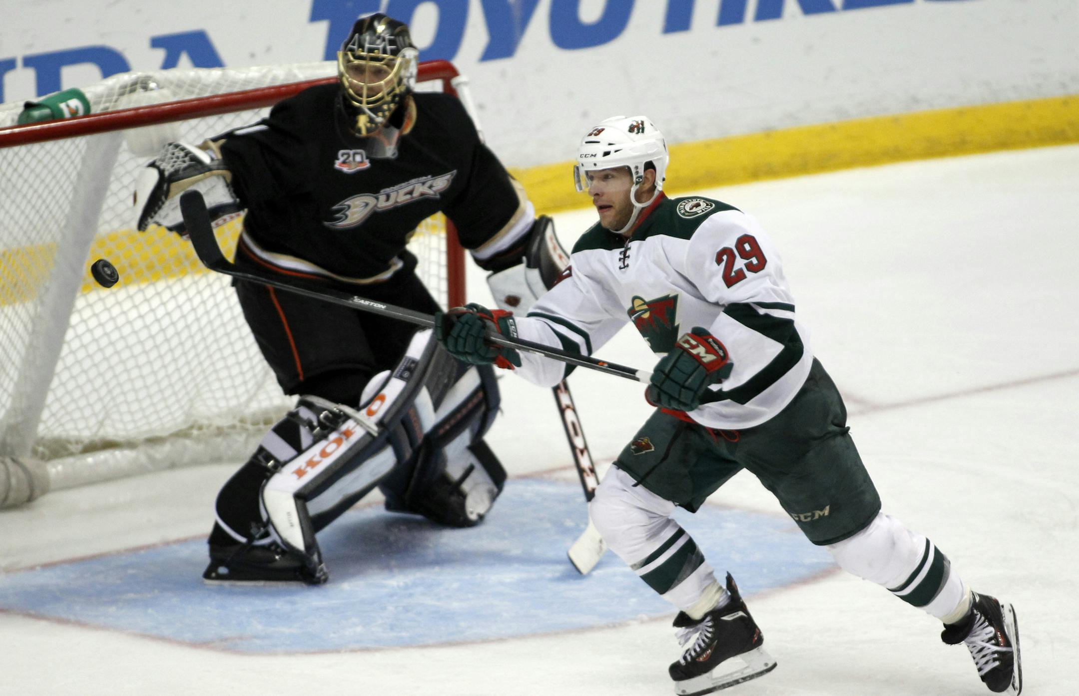 Minnesota Wild right wing Jason Pominville (29) gets the puck with Anaheim Ducks goalie Jonas Hiller, left,, of Switzerland defending in the third period of an NHL hockey game Wednesday, Dec. 11, 2013 in Anaheim, Calif. Ducks won 2-1. (AP Photo/Alex Gallardo)