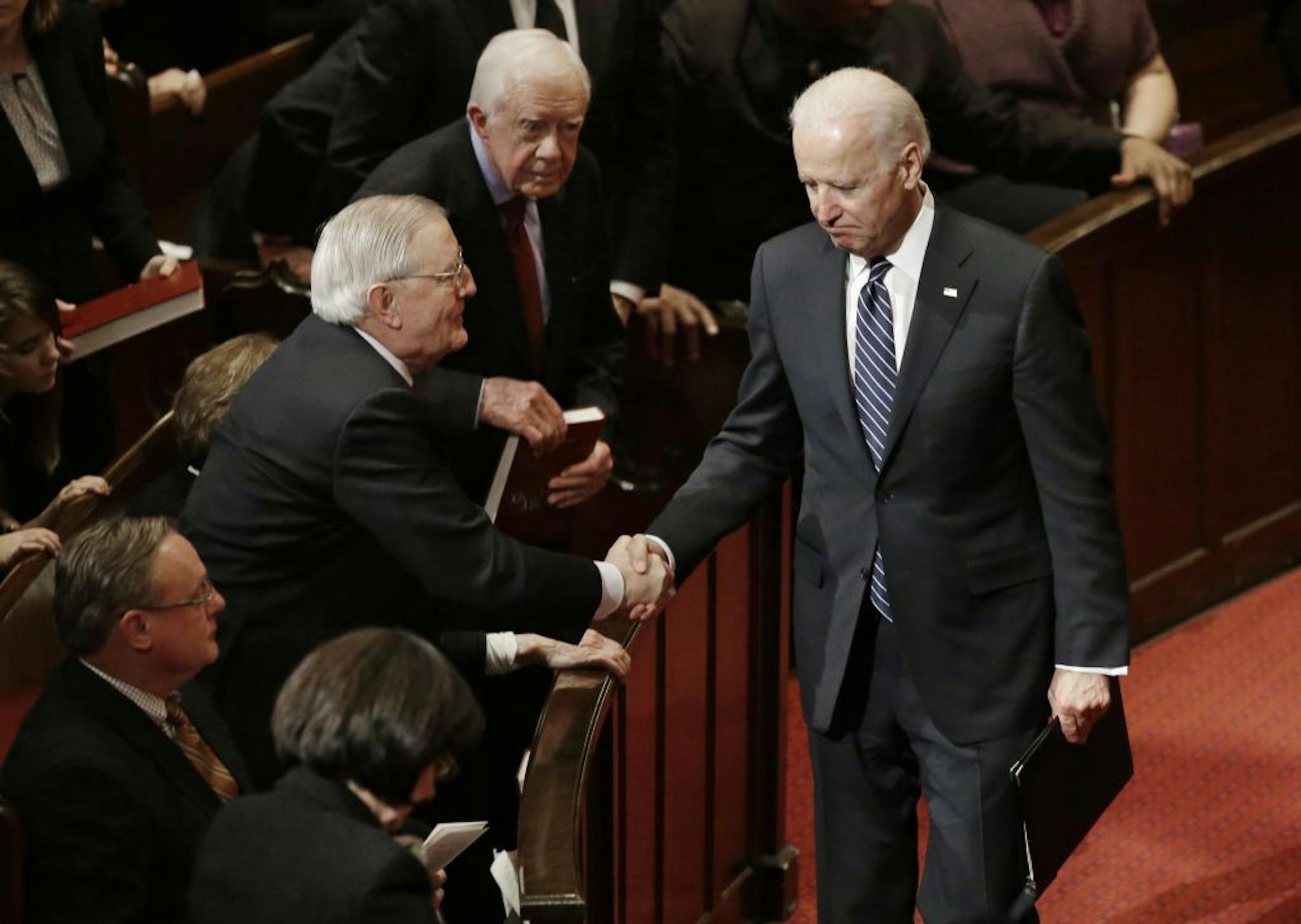 Vice President Joe Biden shakes former Vice President Walter Mondale after Biden paid tribute to Joan Mondale at her memorial service at Westminster Presbyterian Church, Saturday, Feb. 8, 2014 in Minneapolis. Joan Mondale, 83, died Feb. 3.