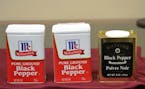 In a photo that accompanied Watkins' original court filing, two similarly-sized tins of McCormick black pepper are shown next to a Watkins tin. The Mc