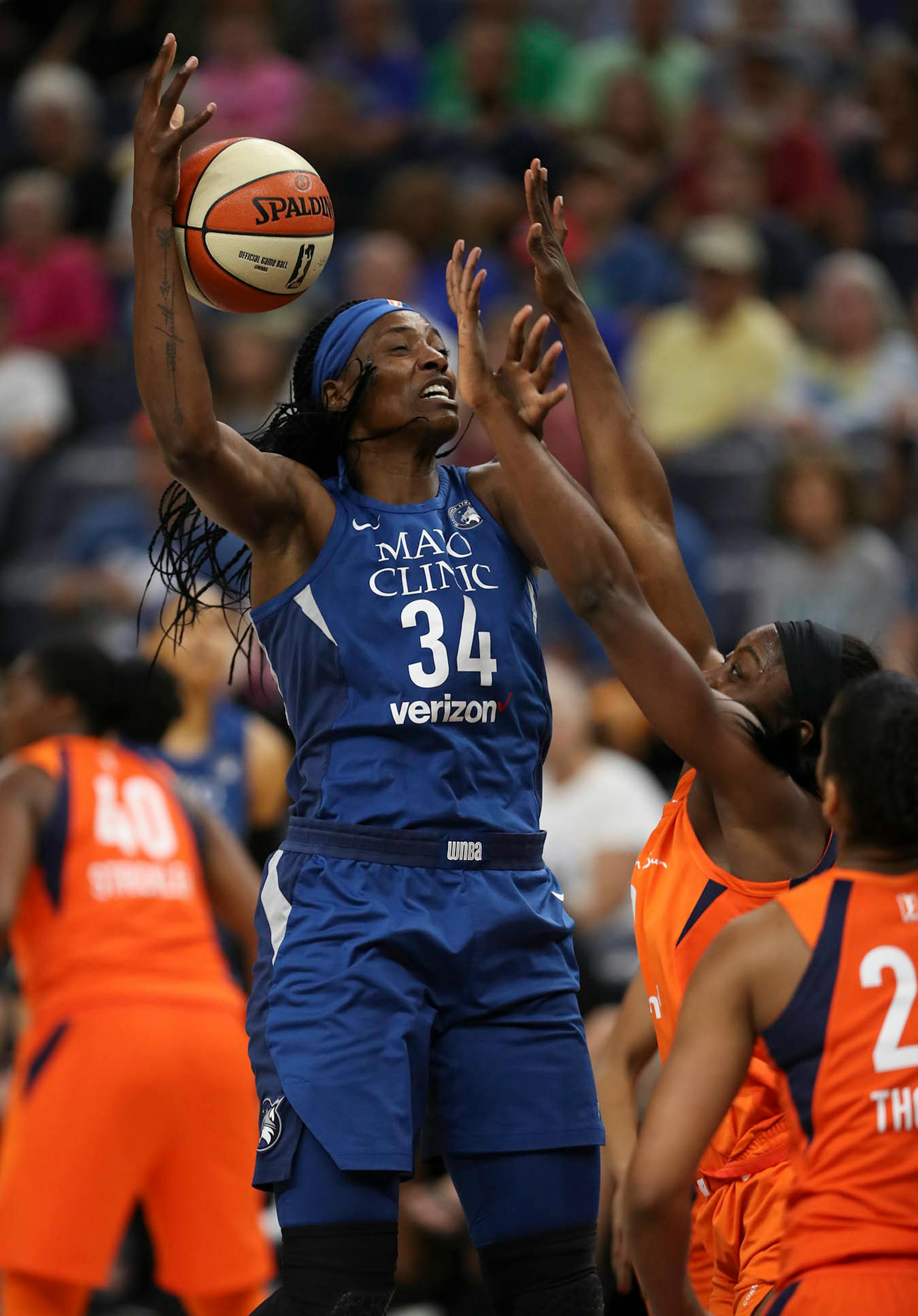 Minnesota Lynx center Sylvia Fowles (34) lost control of the ball as she was fouled by Connecticut Sun forward Chiney Ogwumike (13) in the first quarter.