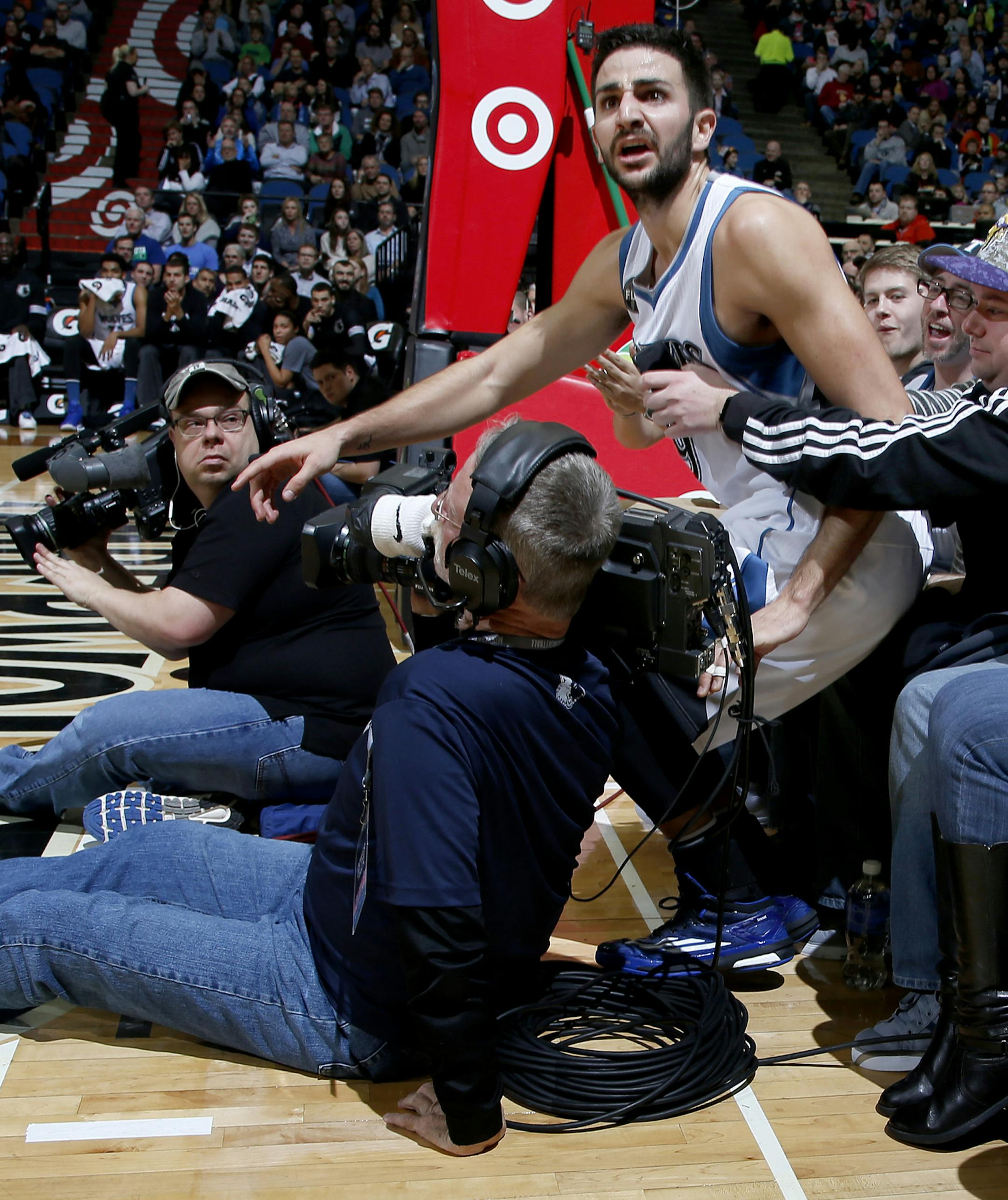 Timberwolves guard Ricky Rubio (9) fell into the first row during a play in the first quarter.