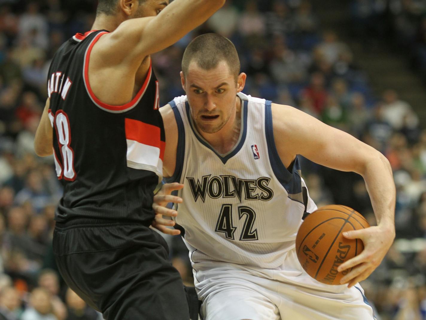 Timberwolves vs Portland. (left to right) Portland's Nicolas Batum stopped Wolves Kevin Love as he drove to the basket in second half action.