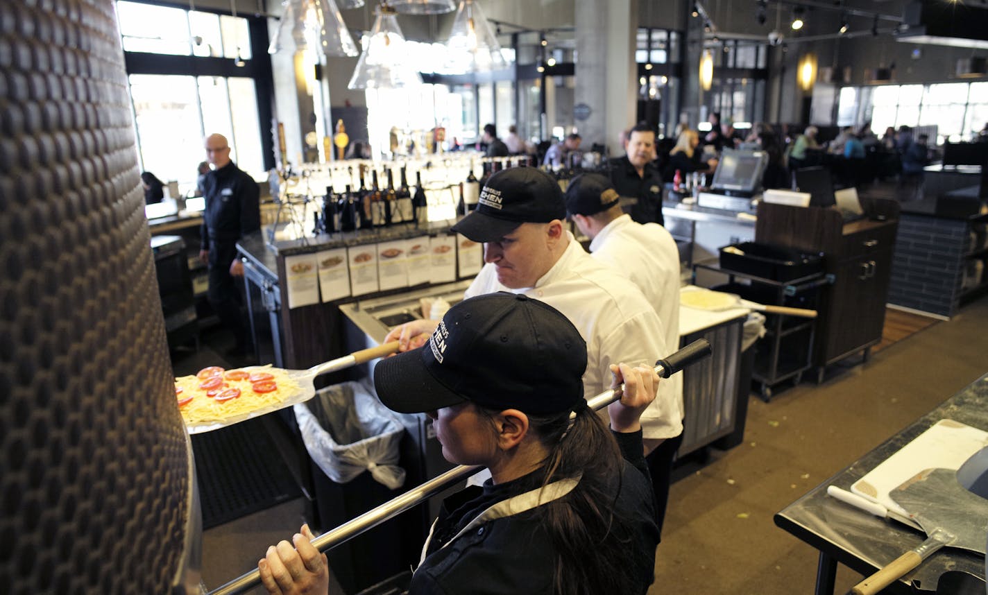 At the Lunds and Byerly's Kitchen in downtown Wayzata, Jessica Huinker and Cort Eggleston baked some pizzas in the gas fired oven. ]richard.tsong-taatarii/rtsong-taatarii@startribune.com