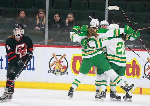A group of fans watched Edina players celebrate a goal by Olivia Swaim, center, at the Class 2A girls’ hockey state tournament in 2018. Limited numb