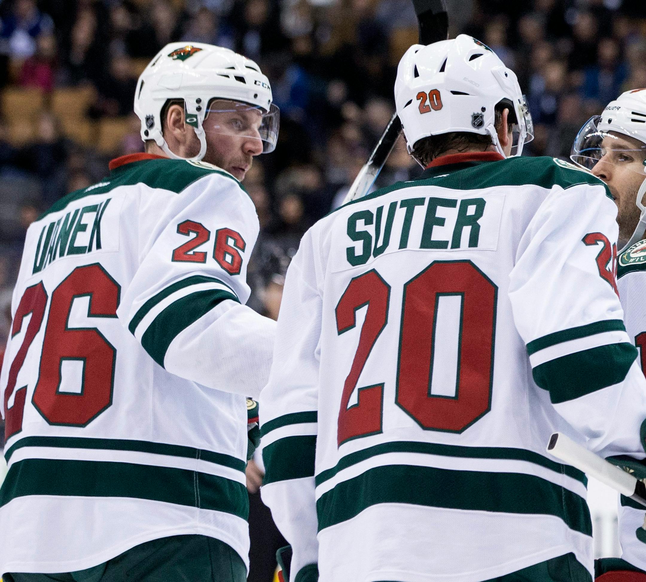 Minnesota Wild's Thomas Vanek, left, celebrates with Ryan Suter (20) and Justin Fontaine after scoring against the Toronto Maple Leafs during third period NHL hockey action in Toronto on Monday, March 23, 2015. (AP Photo/The Canadian Press, Chris Young)