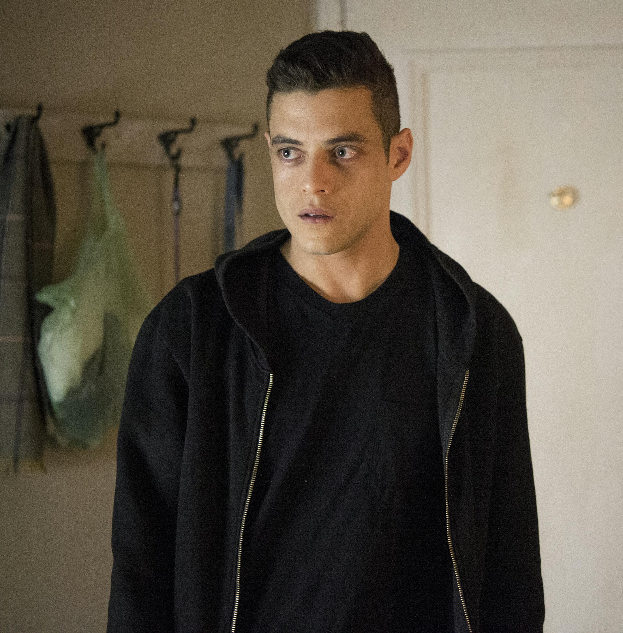 This image released by USA Network shows Rami Malek as Elliot Alderson in a scene from "Mr. Robot." A fake messaging app inspired by the USA Network hacker drama was released Tuesday for mobile devices. "Mr. Robot:1.51exfiltratiOn" casts players as a stranger who finds a mysterious smartphone and begins communicating with the show's characters through an app published by the fictional E-Corp. (David Giesbrecht/USA Network via AP)