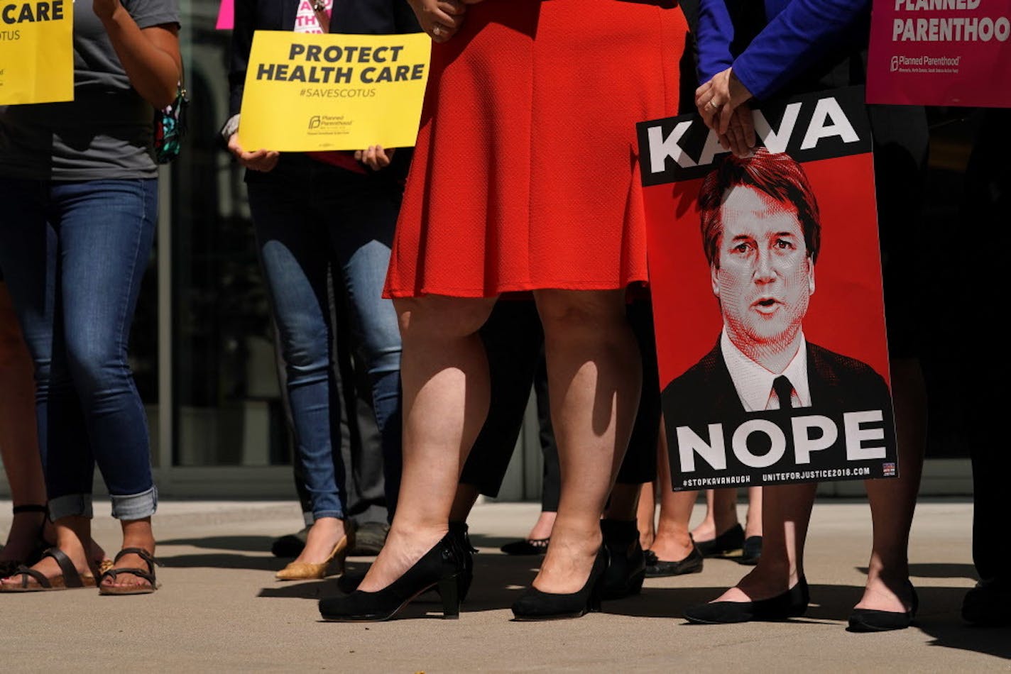 Supporters held signs opposing Brett Kavanaugh's nomination to the U.S. Supreme Court as U.S. Sen. Tina Smith spoke about the issue Friday. ] ANTHONY SOUFFLE � anthony.souffle@startribune.com U.S. Sen. Tina Smith held a press conference to speak about Brett Kavanaugh's nomination to the U.S. Supreme Court and what's at stake for the future of women's reproductive rights, the court, and the country Friday, Sept. 7, 2018 outside Warren E. Burger Federal Building in St. Paul, Minn.