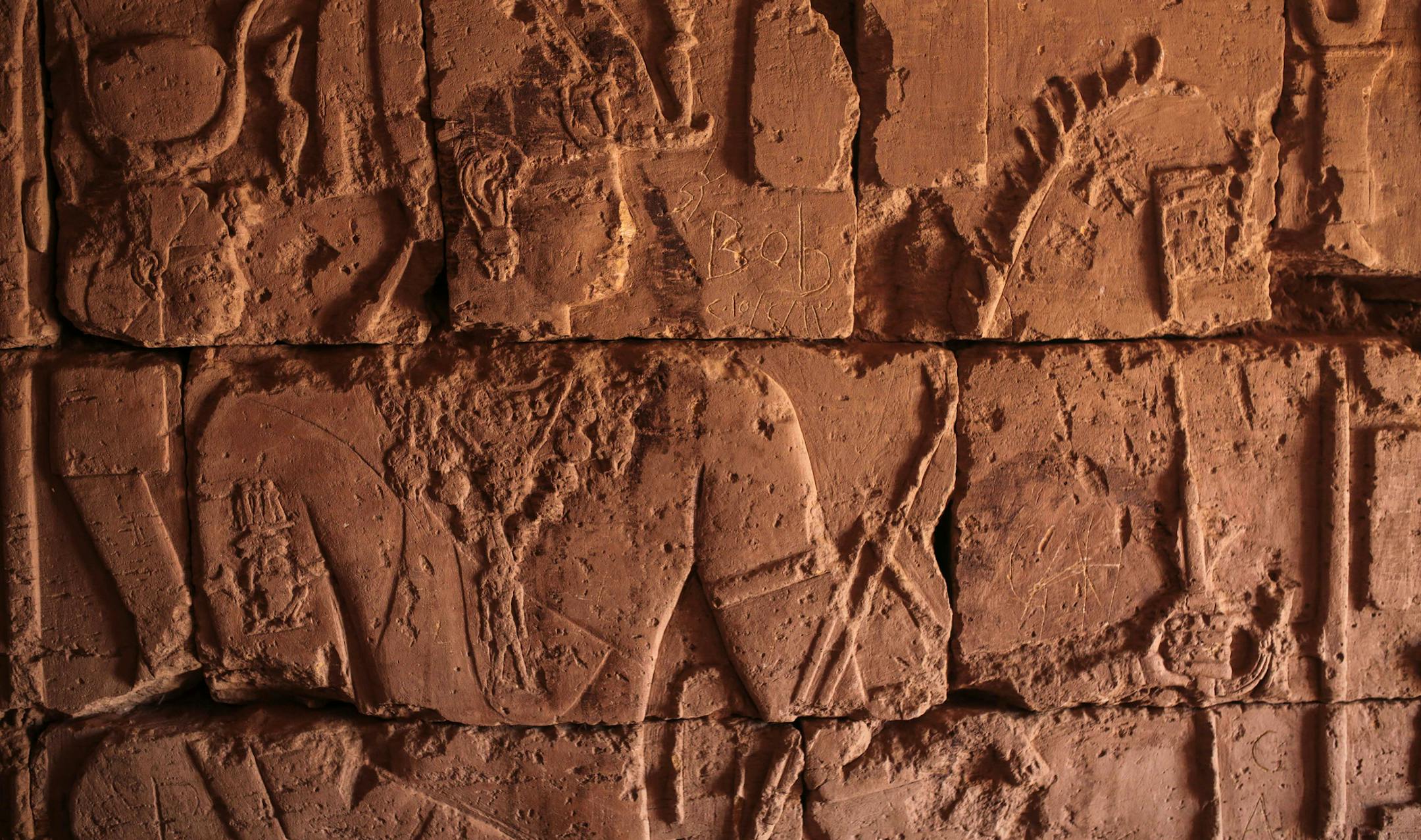 In this Thursday, April 16, 2015 photo, hieroglyphics are pictured inside a room at the historic Meroe pyramids, a sign of the influence of ancient Egyptian civilization on the Sudanese Meroite kingdom, in al-Bagrawiya, 200 kilometers (125 miles) north of Khartoum, Sudan. The pyramids bear decorative elements from the cultures of Pharaonic Egypt, Greece and Rome, according to UNESCO, making them priceless relics. (AP Photo/Mosa'ab Elshamy)
