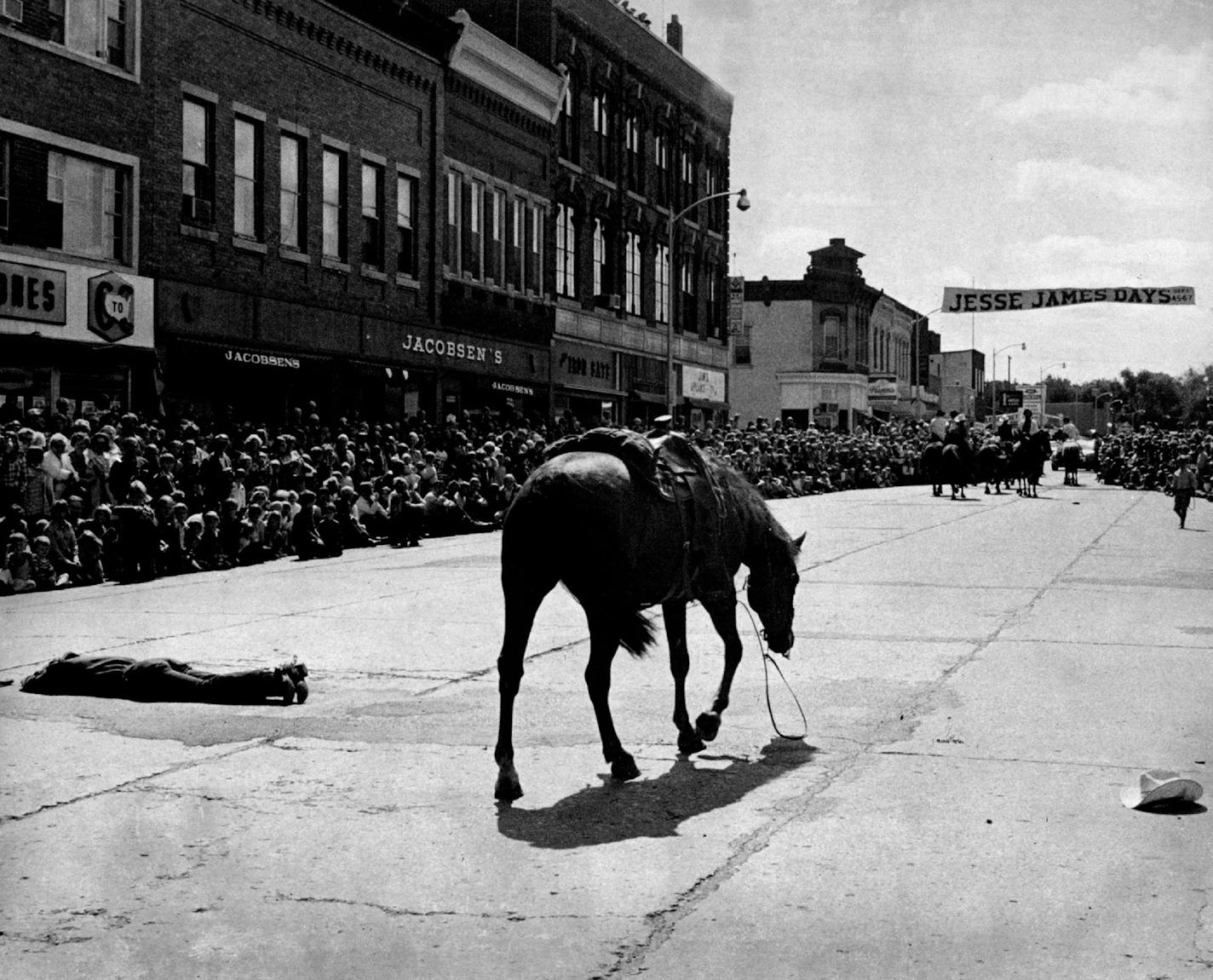 September 8, 1975 'Bad Guy Falls -- A riderless horse walked past a fallen "bad guy" during a re?enactment of the historic Jesse James bank walked past a fallen "bad guy" during a reenactment of the historic Jesse James bank holdup at Northfield, Minn., yesterday. The annual Jesse James festival ended with a parade yesterday afternoon. Two gunmen were killed and two wounded when eight of the James gang unsuccessfully tried to rob the First National bank, Sept. 7, 1876. September 7, 1975 Larry Sc